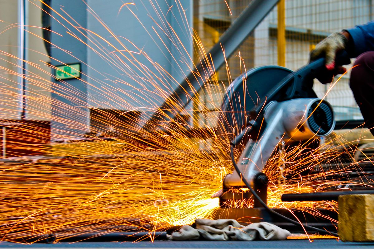 Heavy equipment arm and crew performing on-site technical work