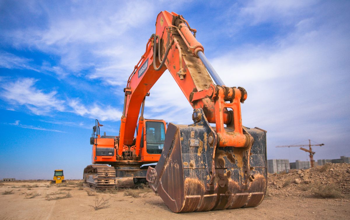Drilling rig and heavy machinery on an active construction site